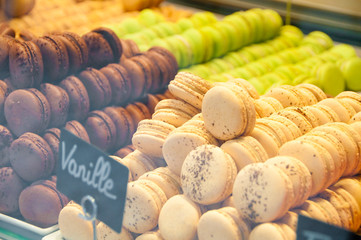 Colorful french sweets macarons in shop window