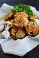 Mushroom muffins on a brown background (close-up)