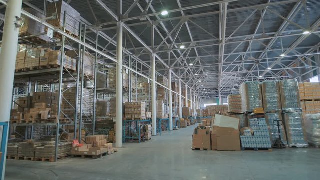 long stack arrangement of goods in a wholesale and retail warehouse depot.