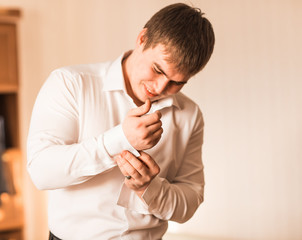 People, business, fashion and clothing concept - man in shirt dressing up at home.