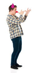 Handsome man clown isolated on white background. Teen boy with crazy look making faces and wearing red nose.