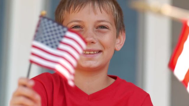 Boy waving American flag