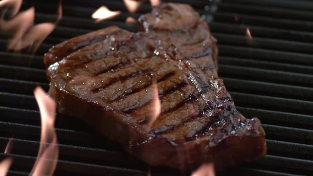 T-Bone steak on grill in slow motion, shot on Phantom Flex 4K