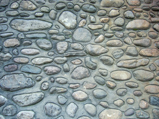 Fototapeta na wymiar round river stone grey wall