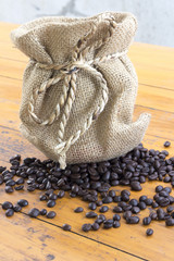 coffee beans and bag on wood background