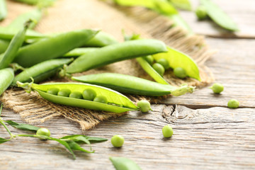 Green peas on a grey wooden table