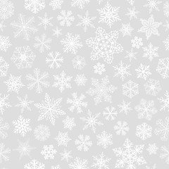 Seamless pattern of snowflakes, white on gray