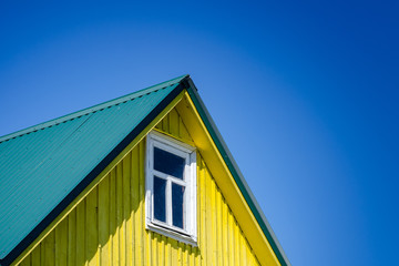 The Roof Of The House With A Wooden Facade And Window Against The Sky. Architecture. Texture, Background Series.