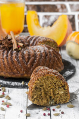 homemade cake with pumpkin on wooden background