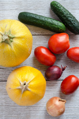 Healthy Food Background. Different Fresh Vegetables On A Wooden White Table. Tomatoes, Zucchini, Eggplant, Onion. Top View .