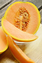 Honeydew melon makes a refreshing treat on a hot summer day, but it's also a low-calorie and healthy choice any time.
cut sweet Melon on wooden background .
