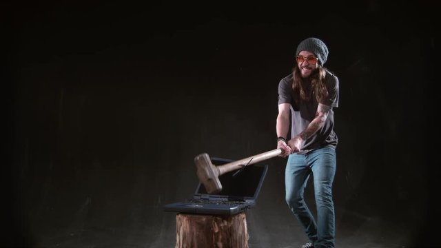 Man smashing laptop with hammer in slow motion, shot on Phantom Flex 4K at 1000 fps