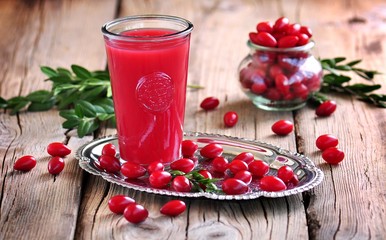 fruit drinks from a cornel on the old wooden background.