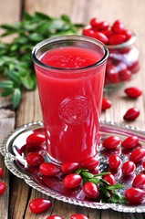 fruit drinks from a cornel on the old wooden background.