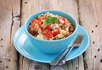 Appetizer (salad) of roasted eggplant, peppers, tomatoes, onions, garlic and coriander.