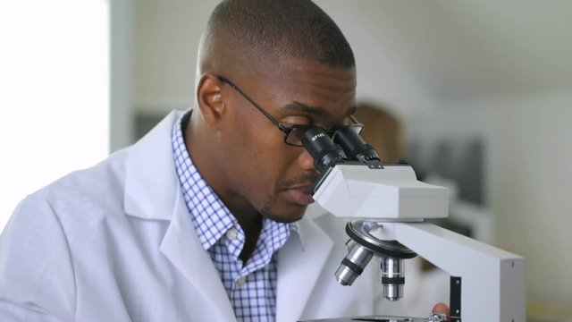 Man looking into microscope