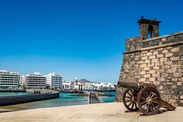 Poster Castillo de San Gabriel - Saint Gabriel Castle in Arrecife and a cannon in front of it, Lanzarote island, Spain  © Tomasz Czajkowski