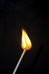 Bright flash sulfur match on a dark background. Beautiful fire close-up.