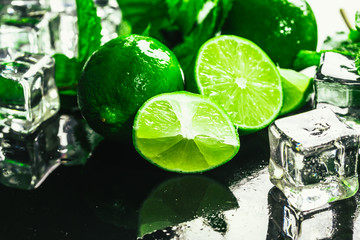fresh green mint and lime ice cube close-up on a dark background