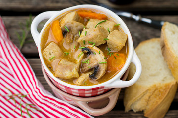 Pork stew with carrots and mushrooms in gravy