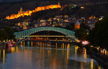 Tbilisi city at night. view on Peace bridge, river Mtkvari and ancient Narikala fortress