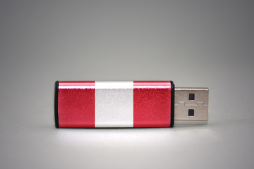 usb flash drive with the national flag of peru on gray background.