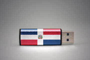 usb flash drive with the national flag of dominican republic on gray background.