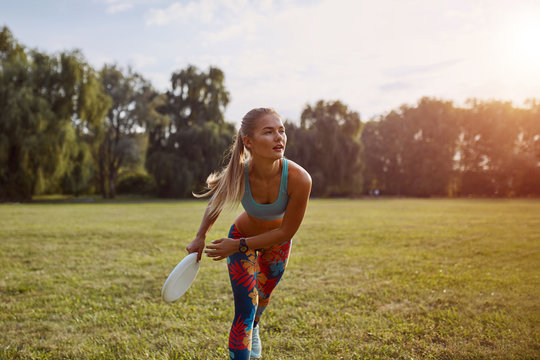 Young athletic girl playing frisbee