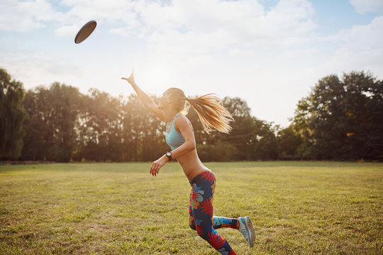 Young athletic girl playing frisbee