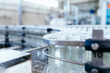 Water factory - Water bottling line for processing and bottling pure spring water into white glass bottles.