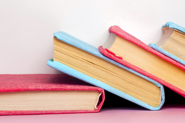 Stack of colorful books, grungy blue background, free copy space