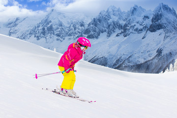 Little girl skiing in the mountains