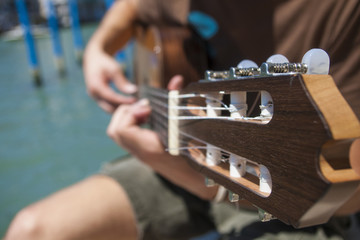 A closeup of a guitar player strumming.