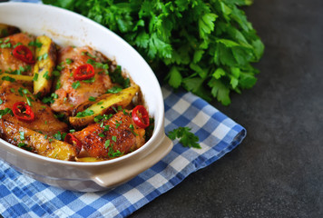 Baked, marinated chicken with potatoes and rosemary