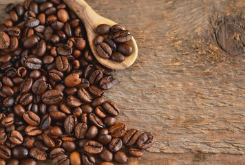 Fototapeta premium Roasted, coffee beans on the wooden background - Arabica