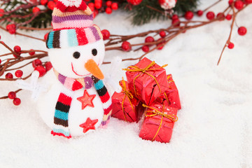 Snowman made of wool over the snow. Christmas decoration