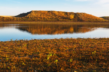 Hill reflected in lake