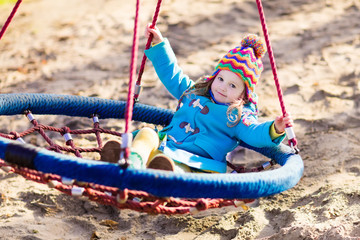Child on playground swing