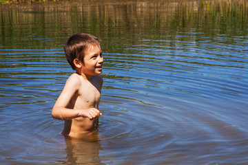 Fototapeta premium Boy bathing in river