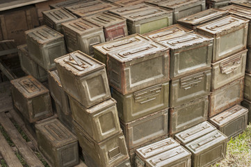 A stack of ammunition tins
 full of bullets.