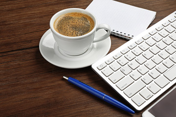 Obraz na płótnie Canvas Cup of coffee on modern workplace