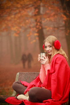 Girl with cup in park.