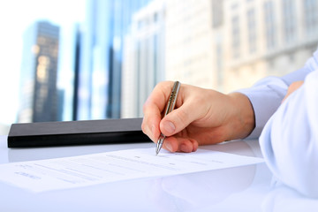 Businessman is signing a contract, business contract details