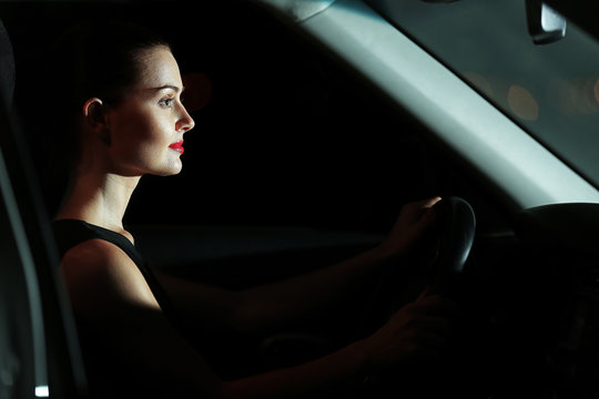 Beautiful young woman driving car