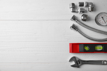 Plumber tools on white wooden background