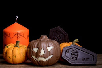 pumpkins, chocolate pumpkin, chocolate tomb and candle for halloween