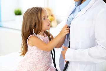 Happy little girl at  health exam at doctor's office