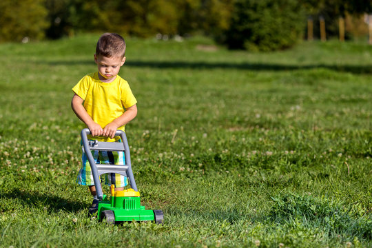 Child Mowing Grass