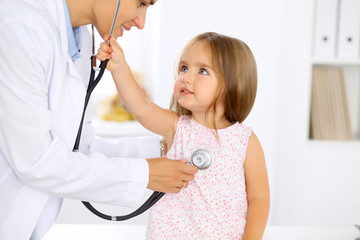 Doctor examining a little girl by stethoscope