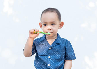 Thai baby boy brushing teeth.